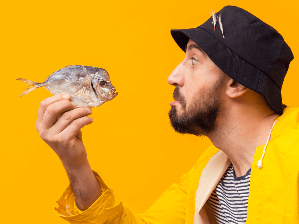 side-view-fisherman-holding-fish-with-copy-space