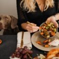 Happy dog eating from a raised stainless steel elevated dog bowl at home