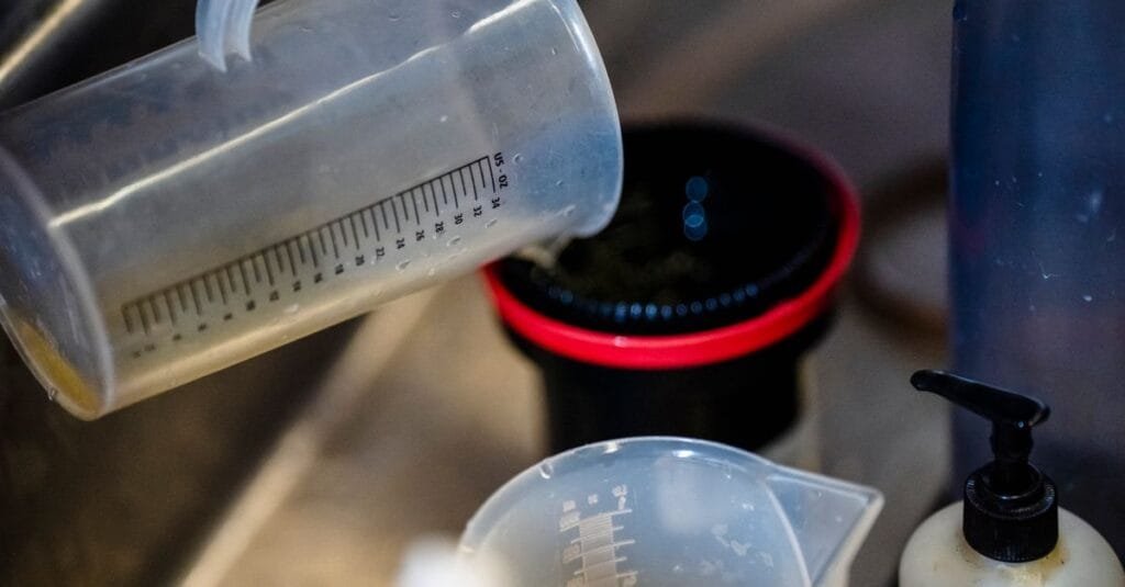 Measuring cup pouring into a container