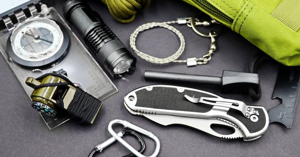Emergency backpack with flashlight compass and gear laid out